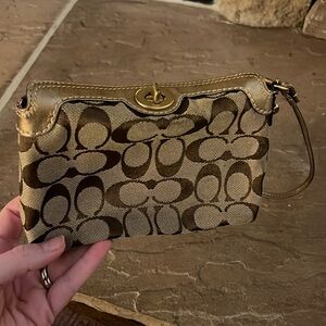 Coach wristlet with gold accents
